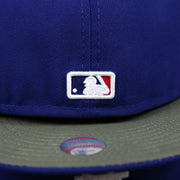 The MLB Batterman Logo on the Los Angeles Dodgers Alpha Industries Side Patch Army Green Undervisor 59FIfty Fitted Cap With Hangtag | Royal Blue 59FIfty Cap