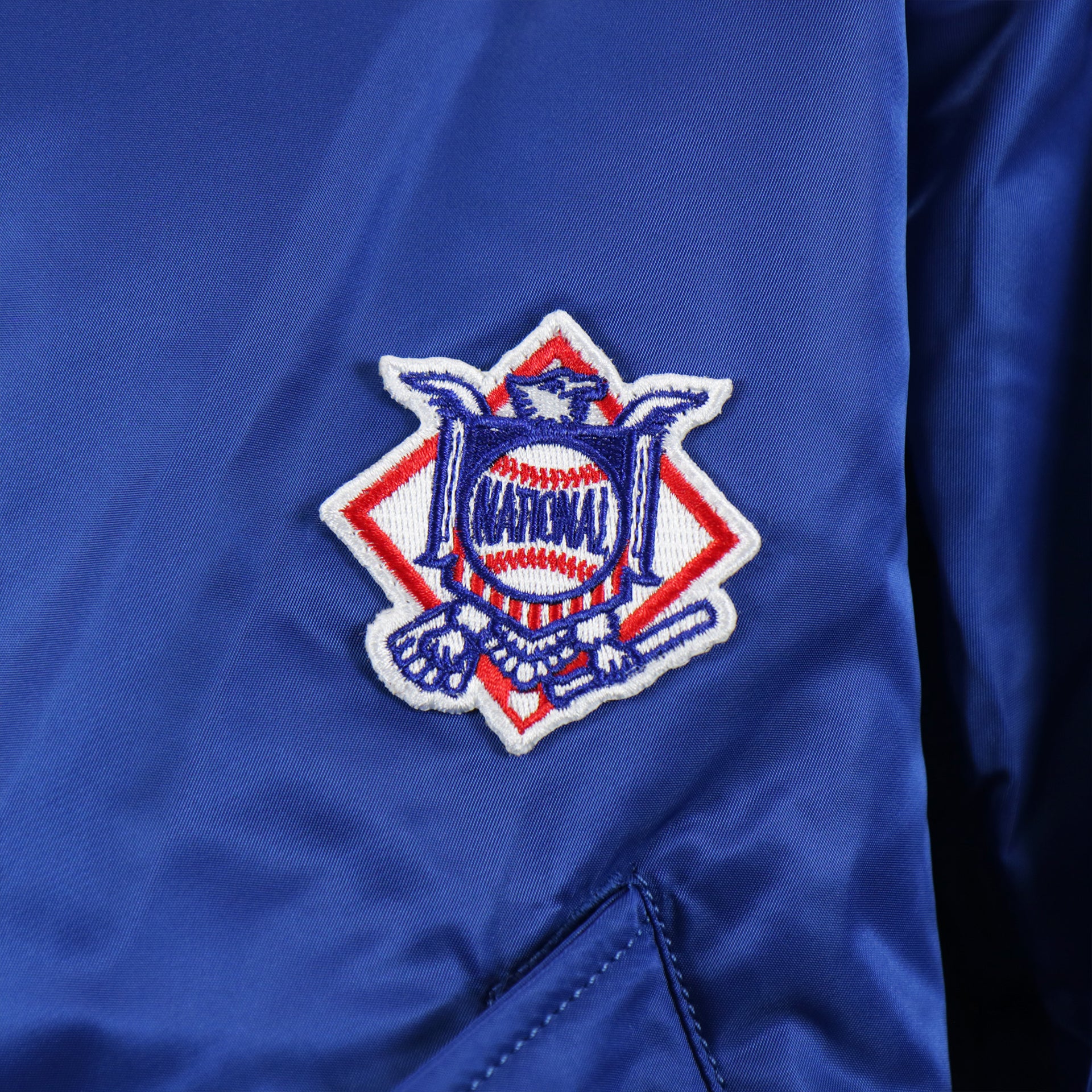 The National League Side Patch on the Cooperstown Brooklyn Dodgers MLB Patch Alpha Industries Reversible Bomber Jacket With Camo Liner | Royal Blue Bomber Jacket
