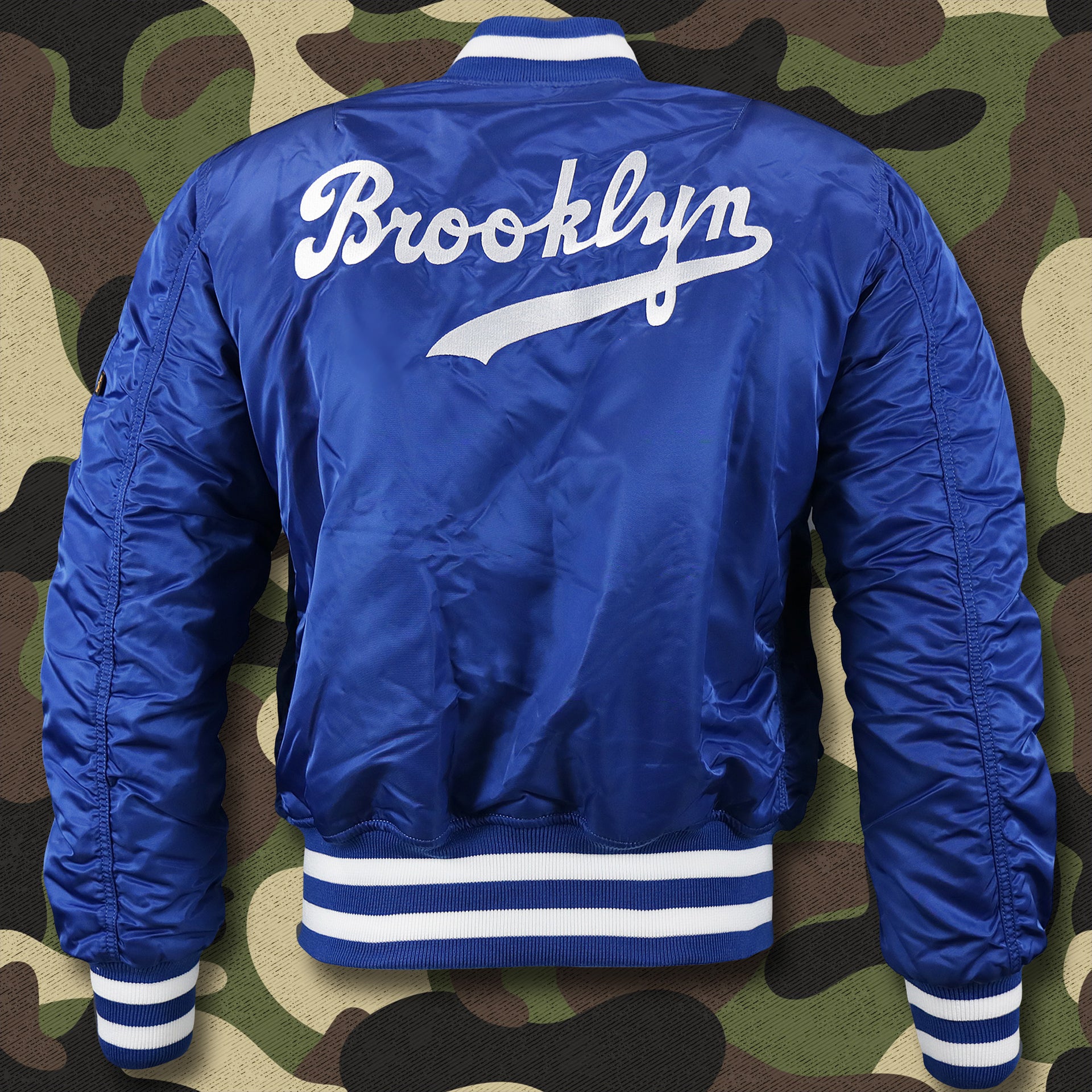 The backside of the Cooperstown Brooklyn Dodgers MLB Patch Alpha Industries Reversible Bomber Jacket With Camo Liner | Royal Blue Bomber Jacket