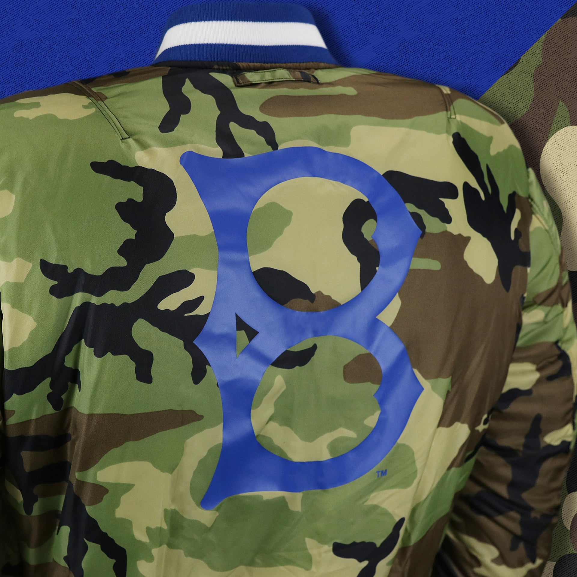 The Brooklyn Dodgers Logo Printed in Blue on the Cooperstown Brooklyn Dodgers MLB Patch Alpha Industries Reversible Bomber Jacket With Camo Liner | Royal Blue Bomber Jacket