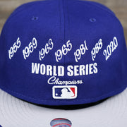 The World Series Wins on the Los Angeles Dodgers Crown Champions Gray Bottom World Championship Wins Embroidered Fitted Cap | Royal Blue 59Fifty Cap