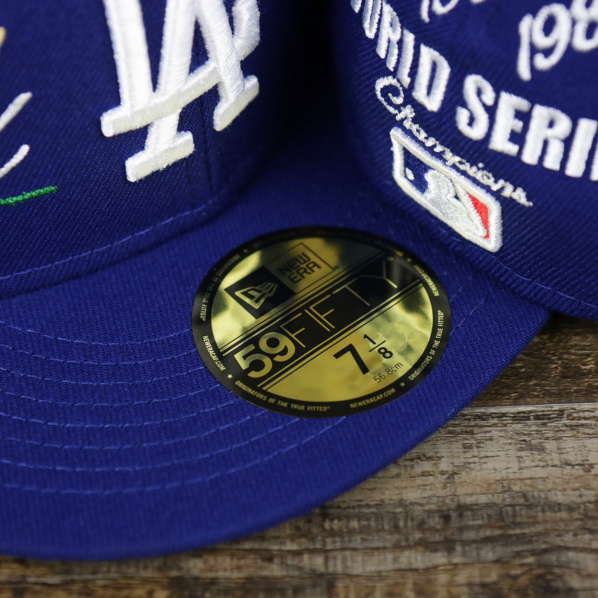 The 59Fifty Sticker on the Los Angeles Dodgers Crown Champions Gray Bottom World Championship Wins Embroidered Fitted Cap | Royal Blue 59Fifty Cap