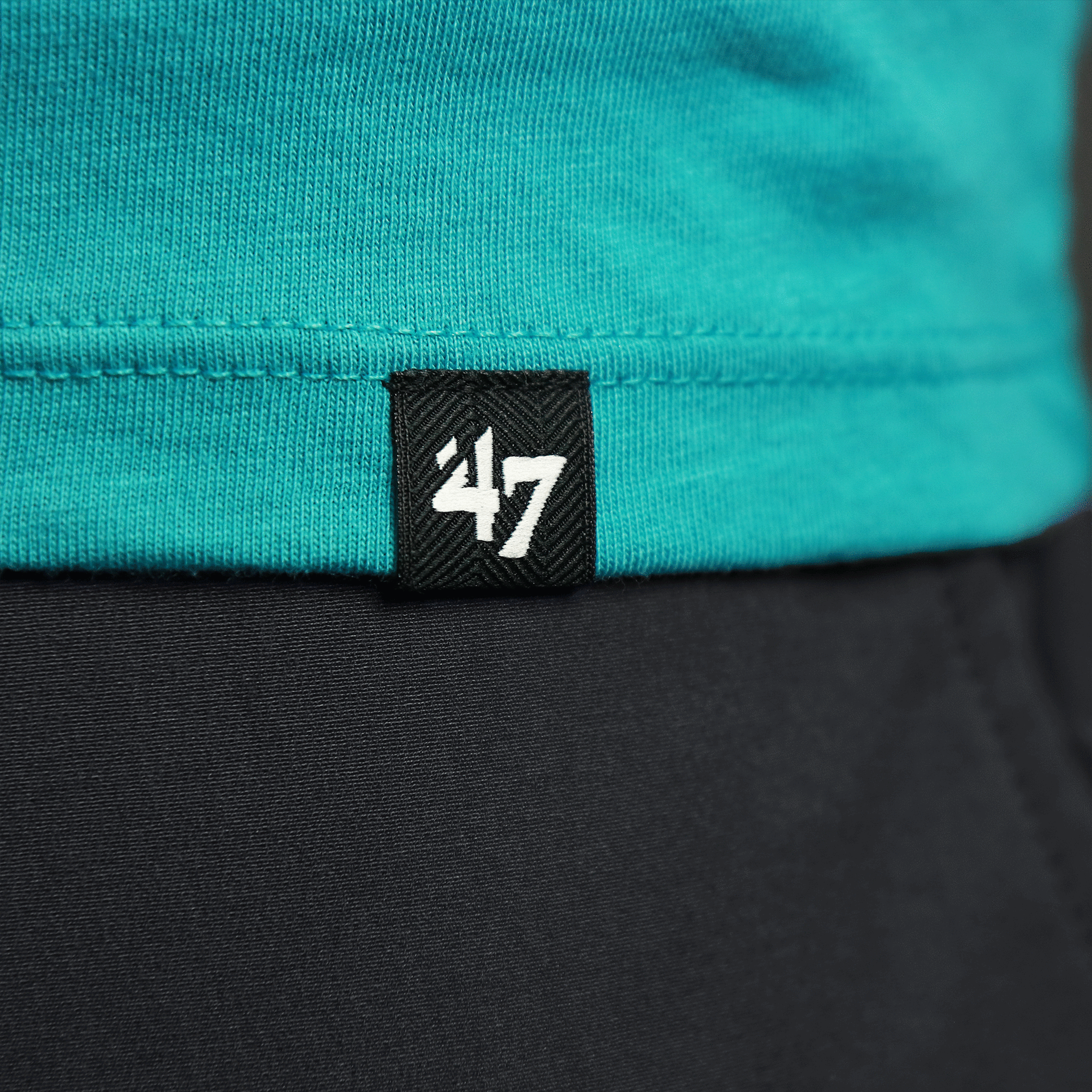 The 47 Brand Tag on the Throwback Miami Dolphins Worn Printed 1974 Dolphins Logo Tshirt | Oceanic Teal Tshirt