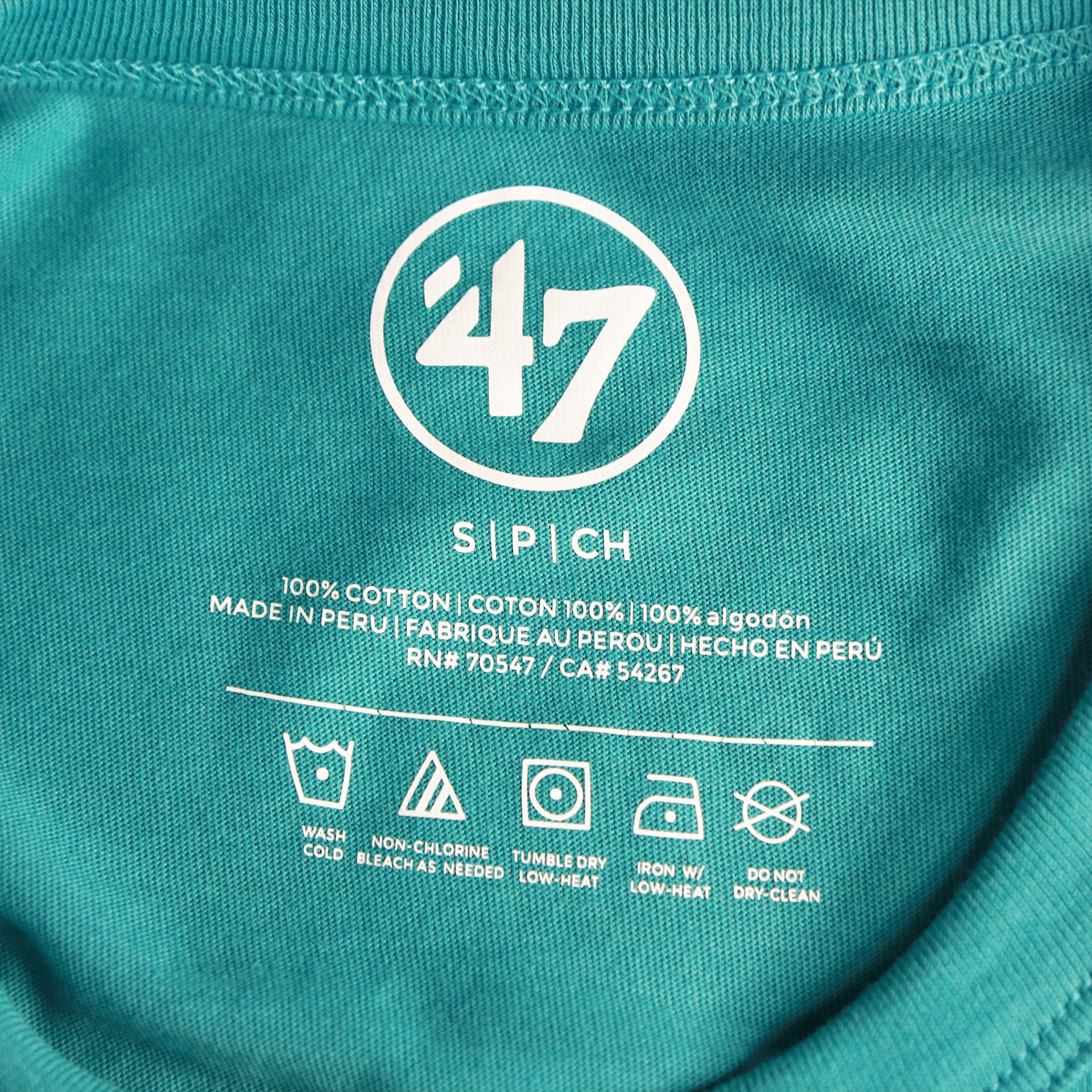 The tags on the Throwback Miami Dolphins Worn Printed 1974 Dolphins Logo Tshirt | Oceanic Teal Tshirt