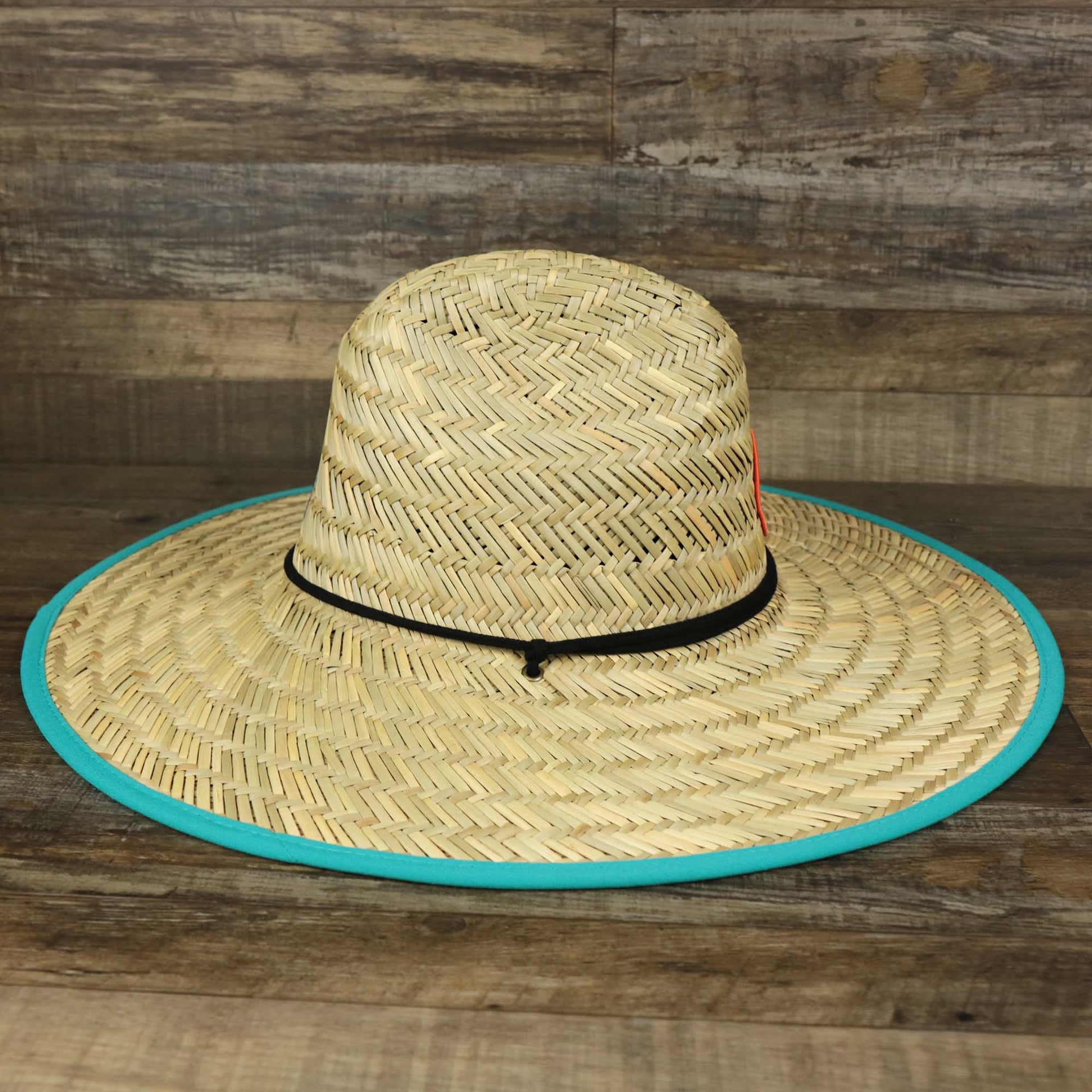 The wearer's right on the Miami Dolphins On Field 2022 Summer Training Straw Hat | New Era OSFM