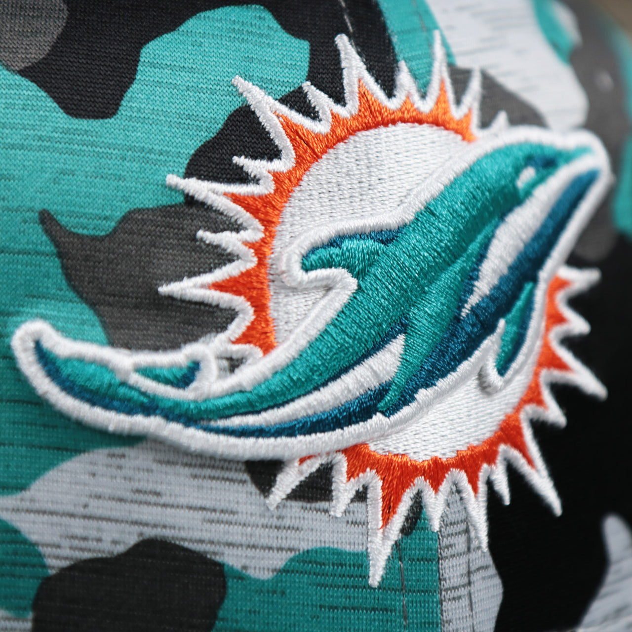 The Logo on the Miami Dolphins NFL OnField Summer Training 2022 Camo 9Fifty Snapback | Turquoise Camo 9Fifty