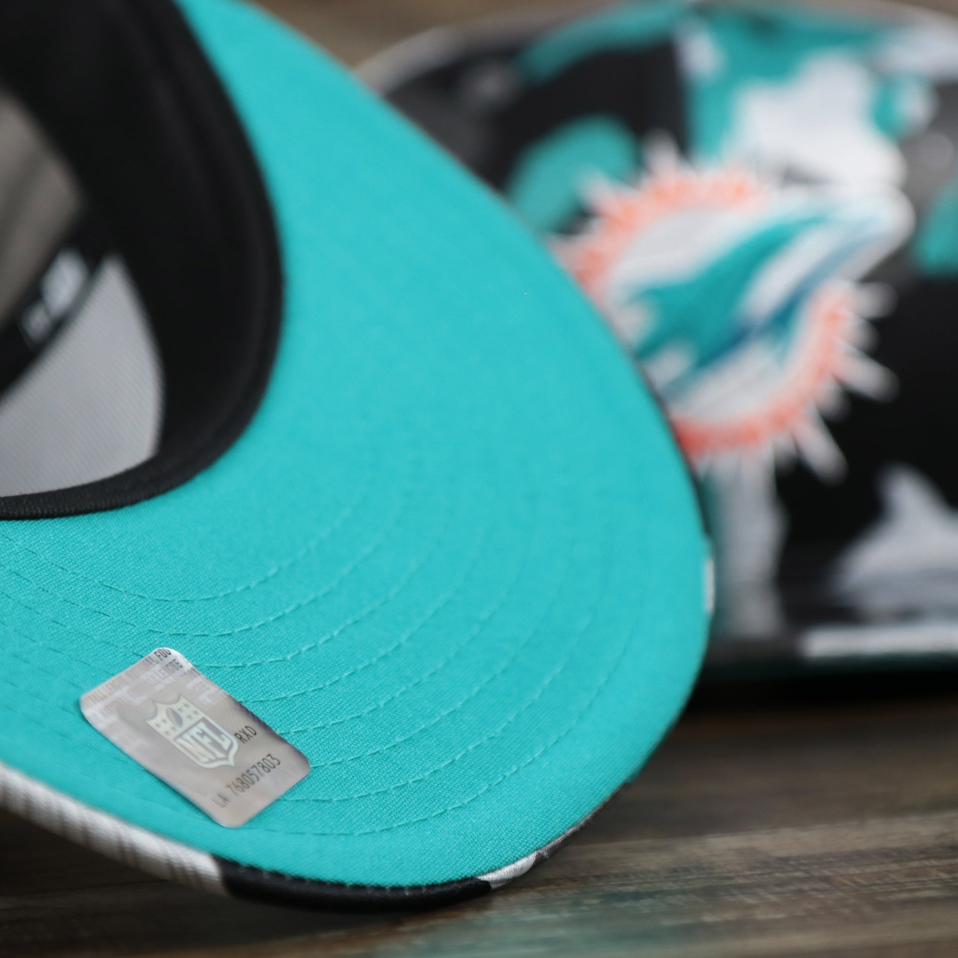 The Under Visor on the Miami Dolphins NFL OnField Summer Training 2022 Camo 9Fifty Snapback | Turquoise Camo 9Fifty