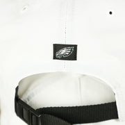 The eagles logo on the Philadelphia Eagles Stars and Stripes Wordmark Gray Bottom Dad Hat | White Dad Hat