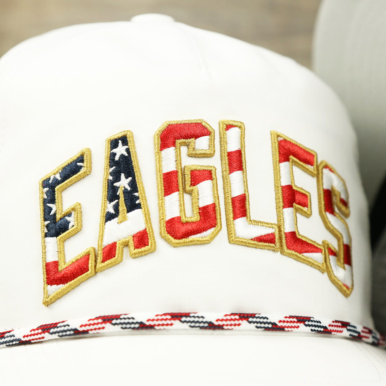 The Eagles Wordmark on the Philadelphia Eagles Stars and Stripes Wordmark Gray Bottom Dad Hat | White Dad Hat