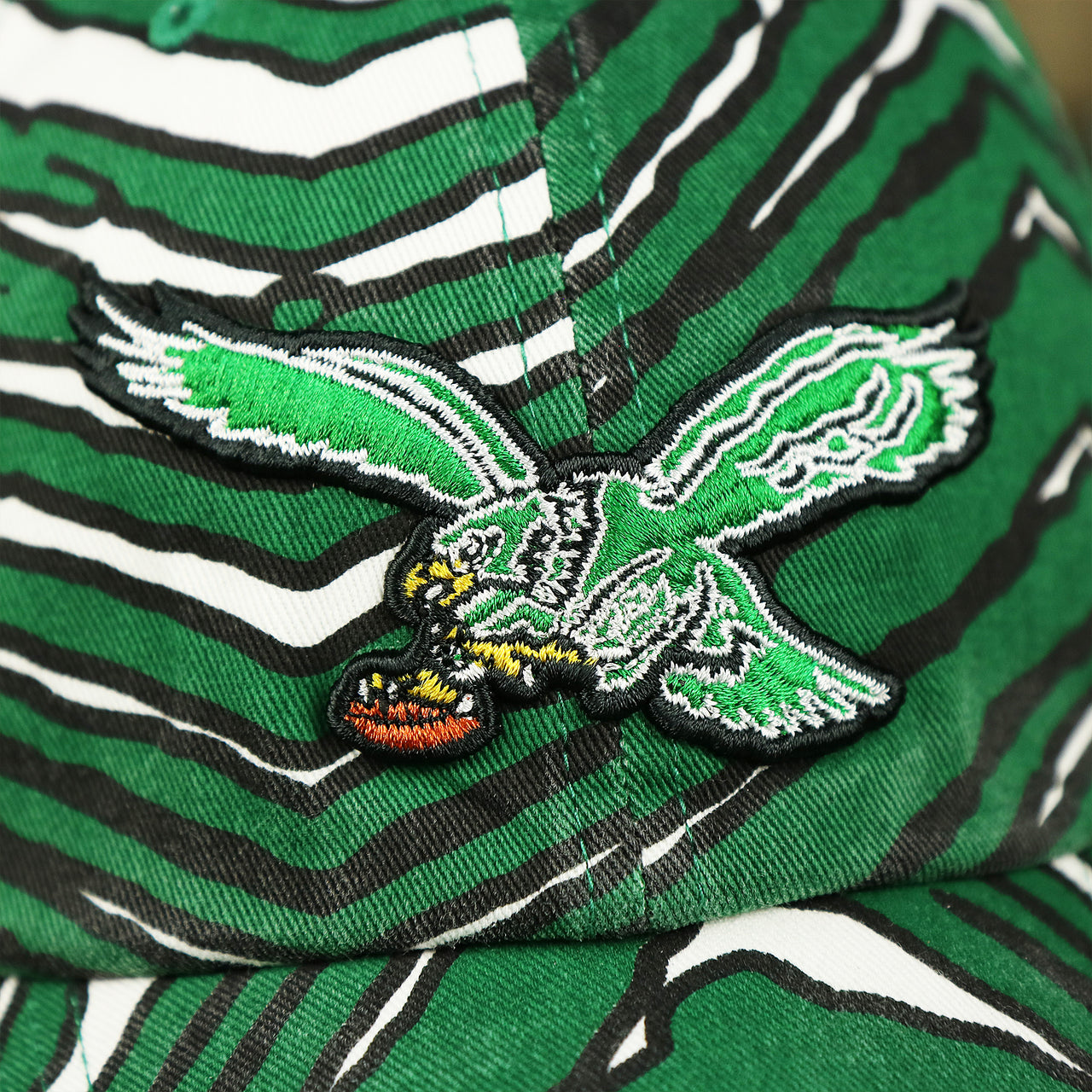 The Eagles Logo on the Throwback Philadelphia Eagles Zubaz Striped Pattern Dad Hat | Kelly Green Dad Hat