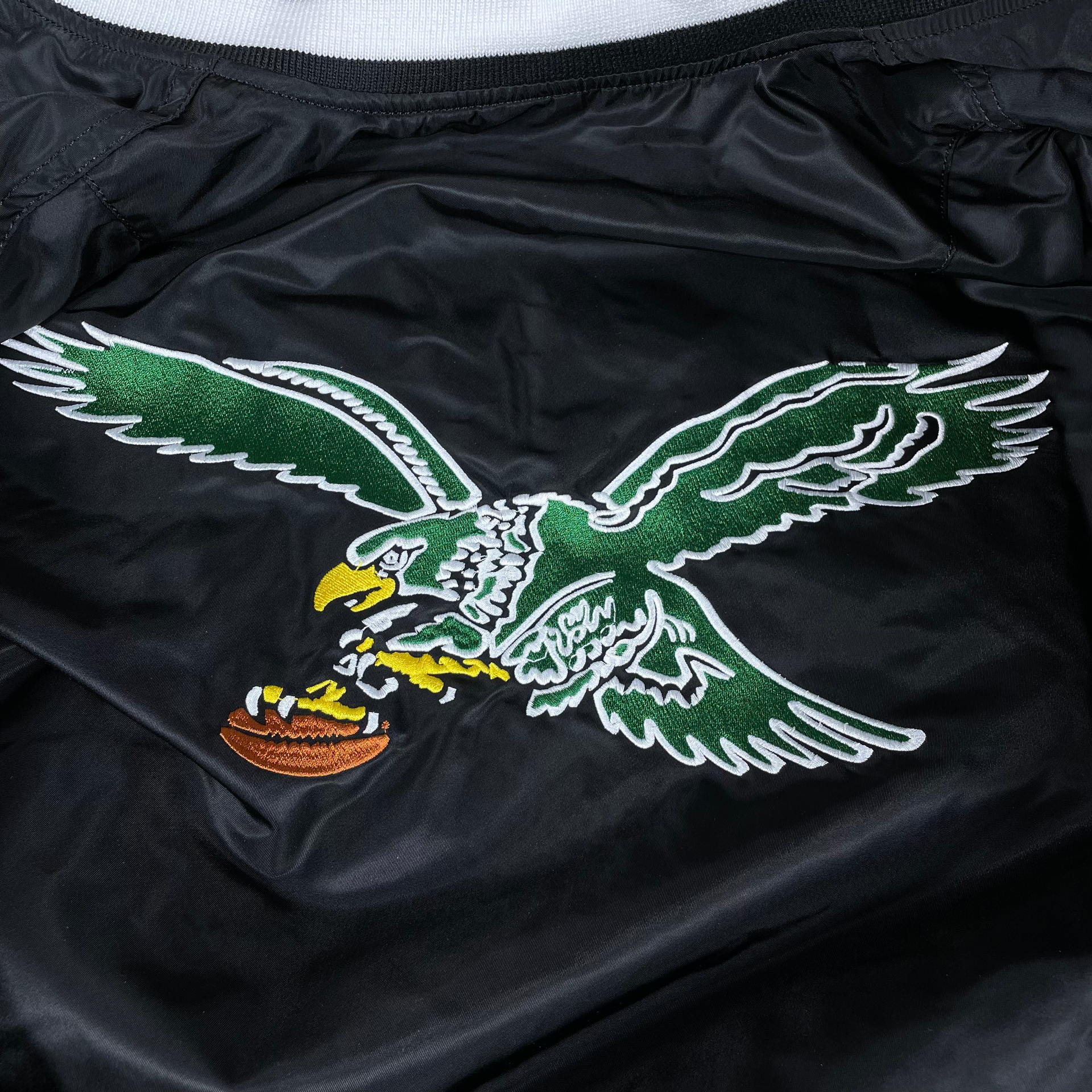 Close up of the back throwback Eagles patch on the Philadelphia Eagles Throwback Men’s Vintage Reversible Bomber Jacket | Alpha Industries x New Era