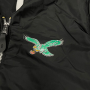 Close up of the reversible left chest Eagles logo on the Philadelphia Eagles Throwback Men’s Vintage Reversible Bomber Jacket | Alpha Industries x New Era