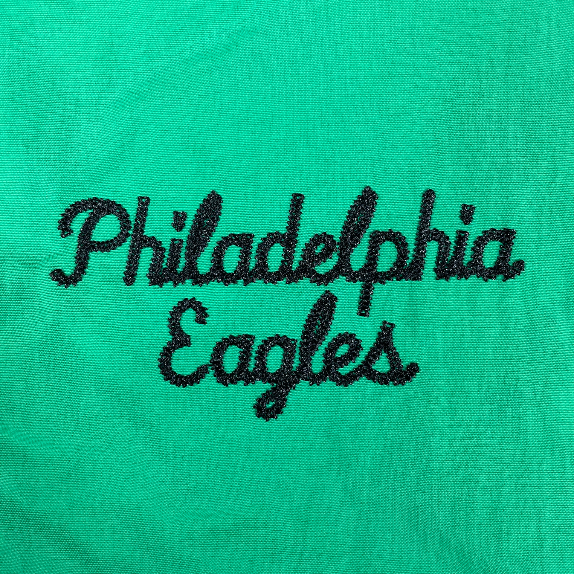 Close up of the chain stitch Philadelphia Eagles word mark on the Philadelphia Eagles Throwback Men’s Vintage Varsity Jacket | Kelly Green