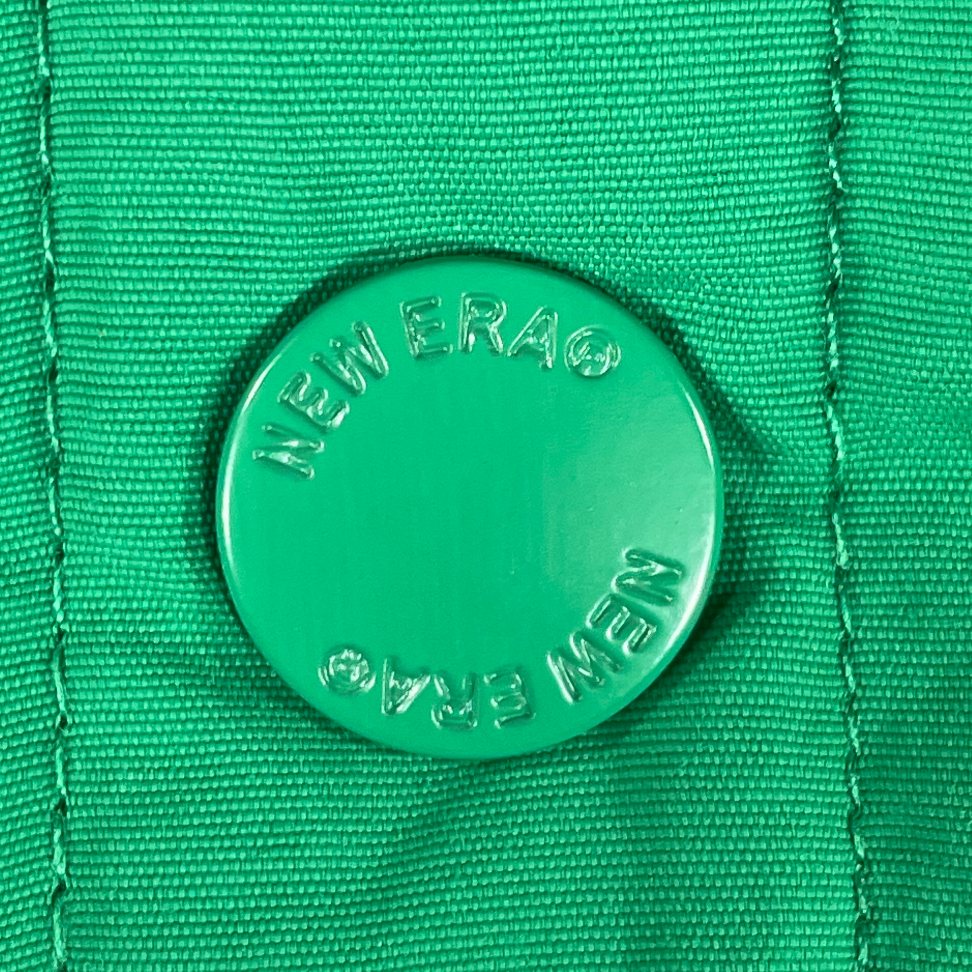 Close up of the button on the varsity jacket of the Philadelphia Eagles Throwback Men’s Vintage Varsity Jacket | Kelly Green