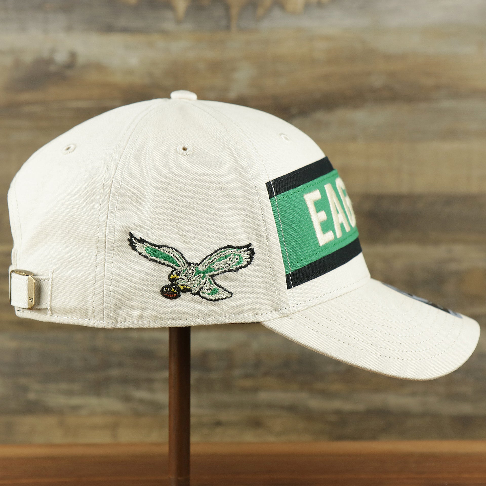 The wearer's right on the Throwback Philadelphia Eagles Striped Wordmark Legacy Eagles Side Patch Crossroad Dad Hat | Bone Dad Hat