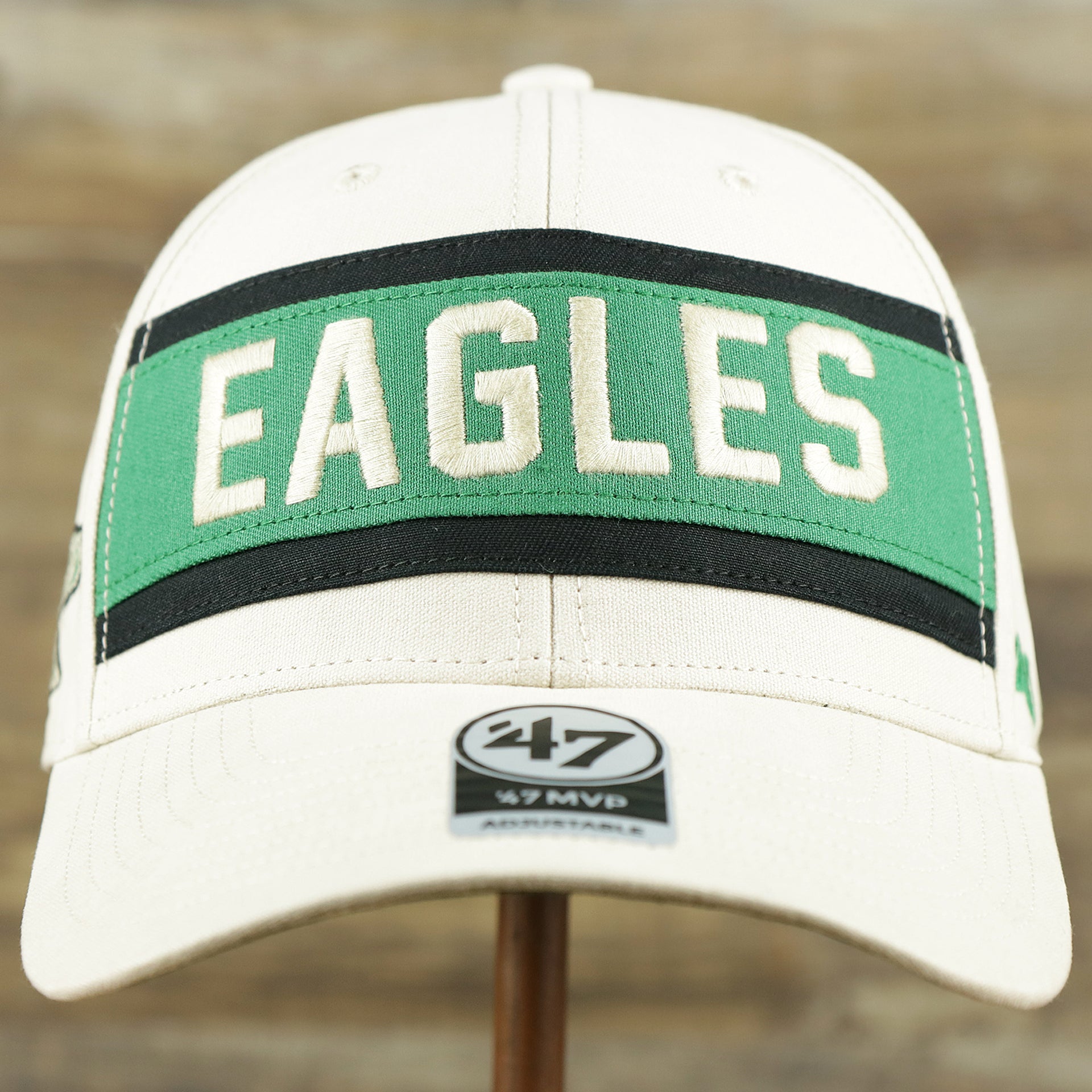 The front of the Throwback Philadelphia Eagles Striped Wordmark Legacy Eagles Side Patch Crossroad Dad Hat | Bone Dad Hat