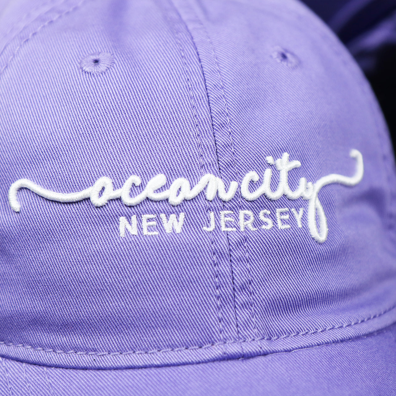 The OCNJ Wordmark on the Ocean City New Jersey Cursive Wordmark Dad Hat | Lavender Dad Hat