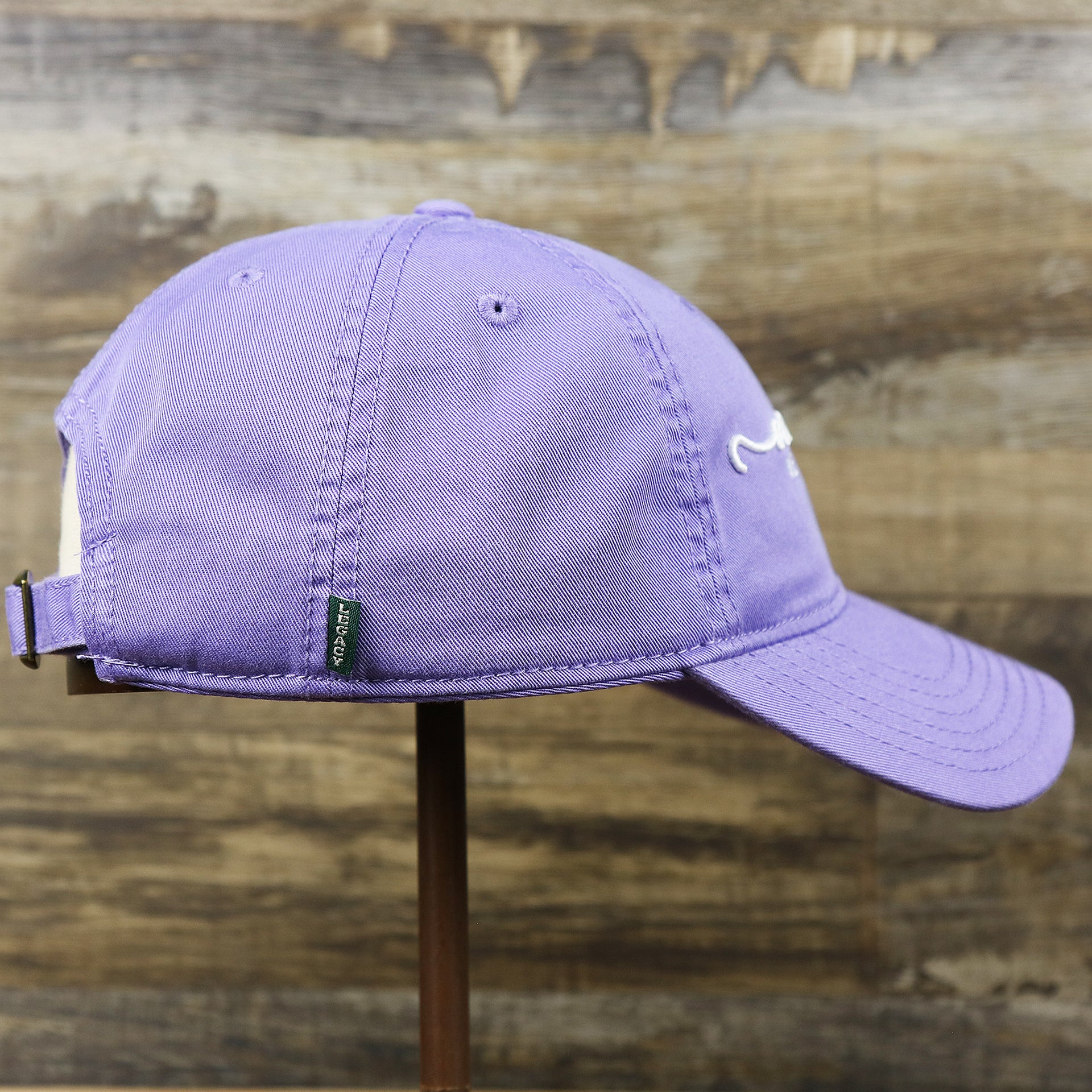 The wearer's right on the Ocean City New Jersey Cursive Wordmark Dad Hat | Lavender Dad Hat
