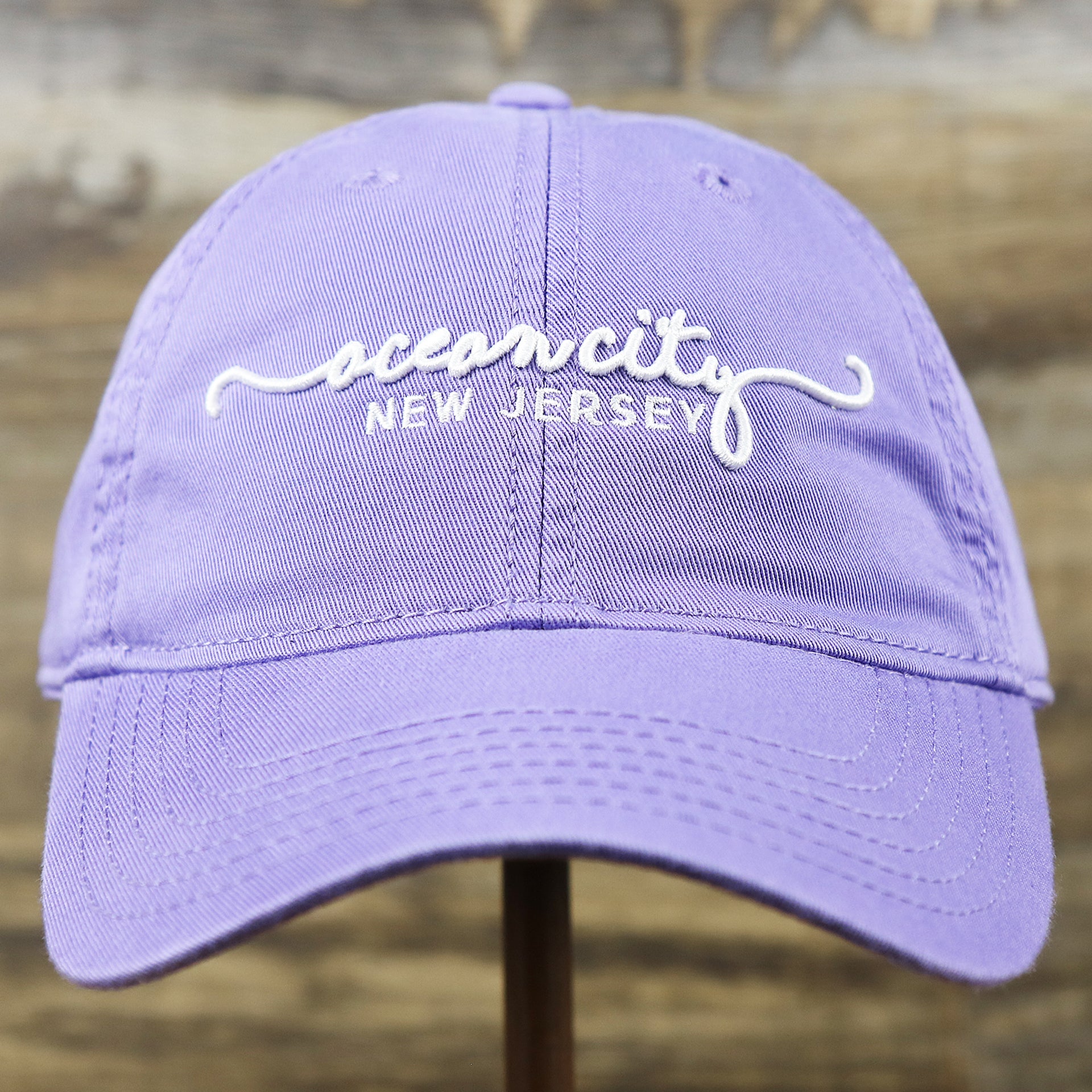 The front of the Ocean City New Jersey Cursive Wordmark Dad Hat | Lavender Dad Hat