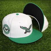 The Throwback Philadelphia Eagles Chrome Logo NFL Eagles SIde Patch 59Fifty Fitted Cap | Cream Fitted Cap with a black undervisor