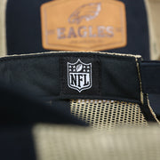 The NFL Tag on the Philadelphia Eagles Leather Patch Mesh Back Trucker Hat | Black Trucker Hat