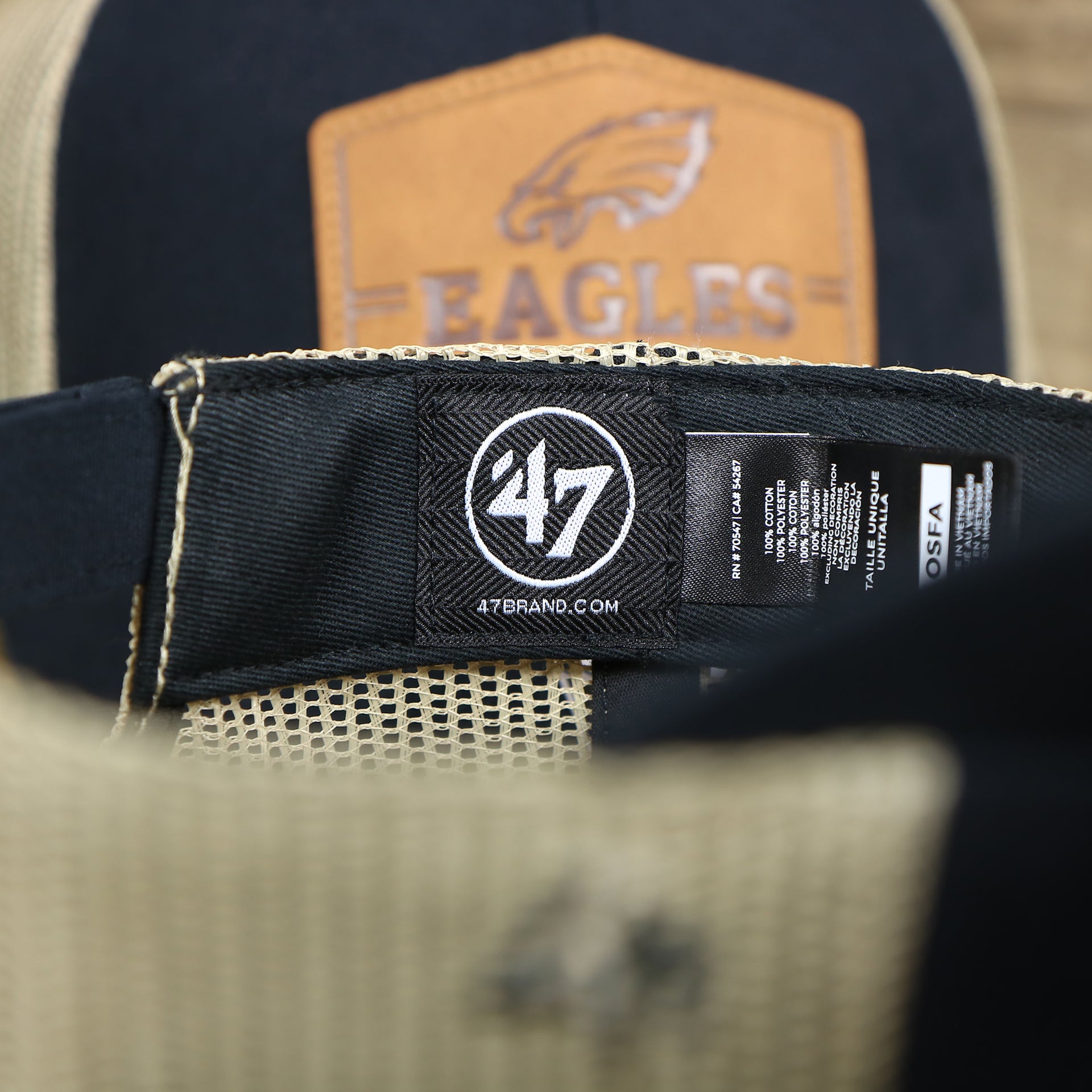 The 47 Brand tag on the Philadelphia Eagles Leather Patch Mesh Back Trucker Hat | Black Trucker Hat