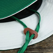 The Chinstrap on the Throwback Philadelphia Eagles 1987 White Eagles Logo Panama Pail Bucket Hat | Kelly Green Bucket Hat