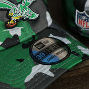The 39Thirty Sticker on the Throwback Philadelphia Eagles OnField NFL Summer Training 2022 39Thirty Camo FlexFit Cap | New Era Kelly Green