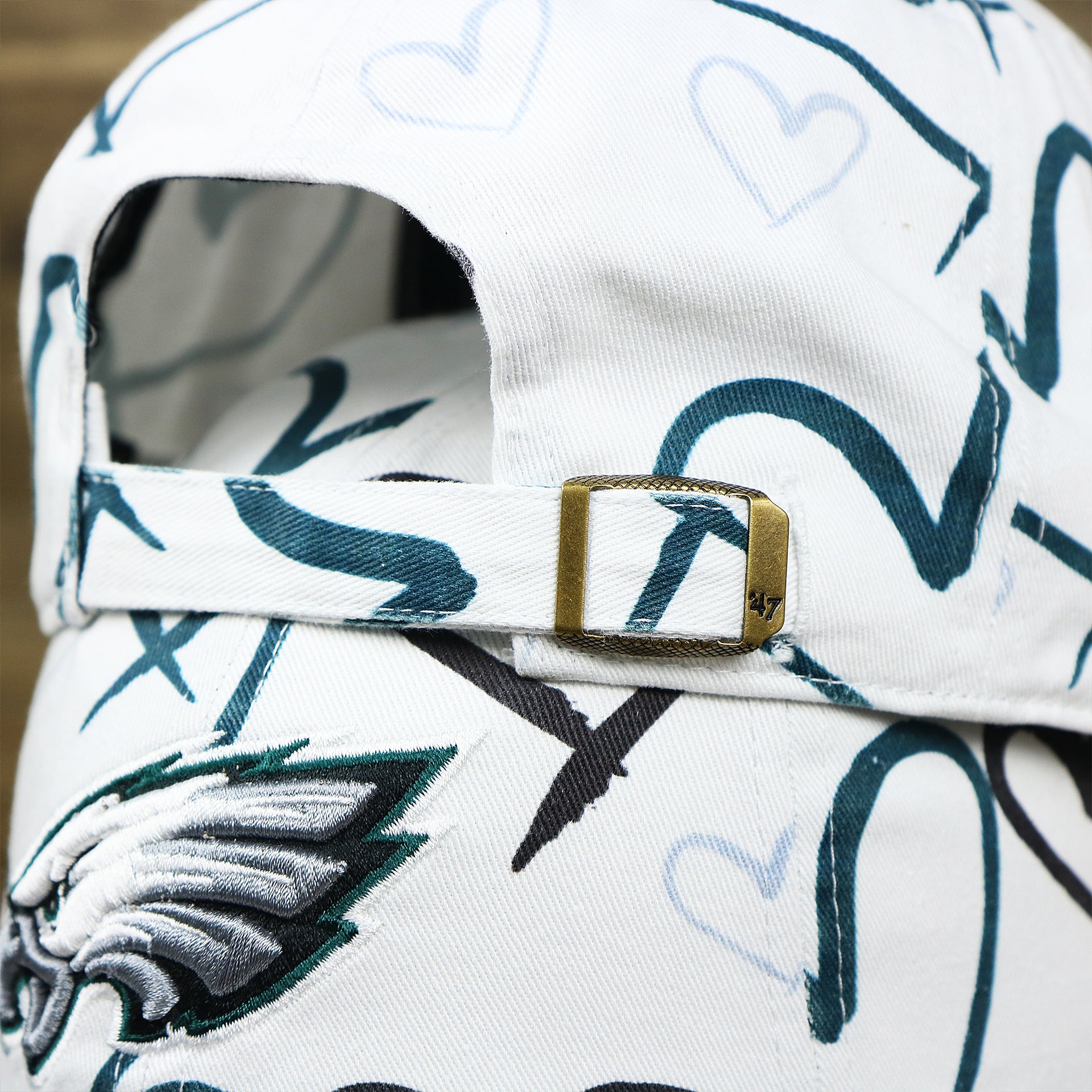 The White Adjustable Strap on the Kids Philadelphia Eagles Hearts All Over Print Dad Hat | White Kid’s Dad Hat