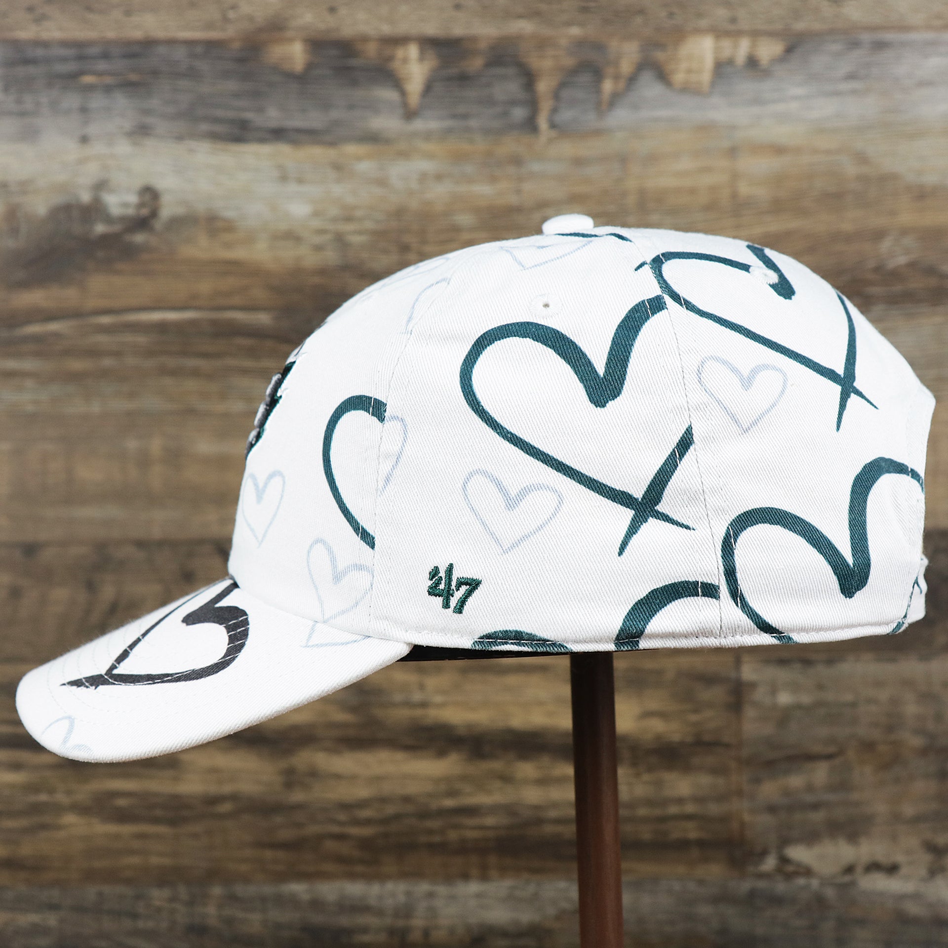 The wearer's left on the Kids Philadelphia Eagles Hearts All Over Print Dad Hat | White Kid’s Dad Hat