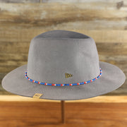 The wearer's left of the Philadelphia 76ers Beaded Wide Brim Fedora Hat With Metal New Era Logo | Gray Fedora Hat