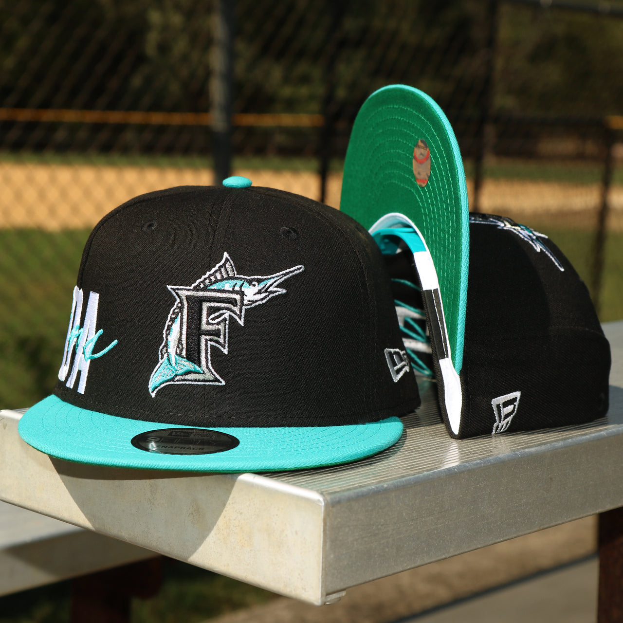 The front of the Cooperstown Florida Marlins MLB Side Font Green Bottom 9Fifty Snapback Cap | Black Snap Cap