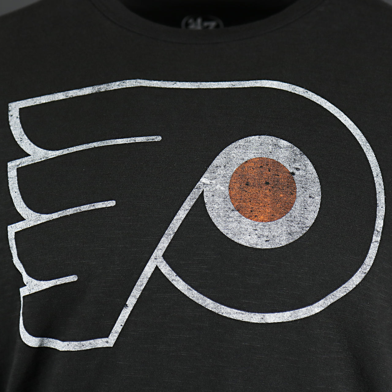 Close up of the front logo on the Philadelphia Flyers Distressed Logo Premium Grit Scrum Black T-Shirt