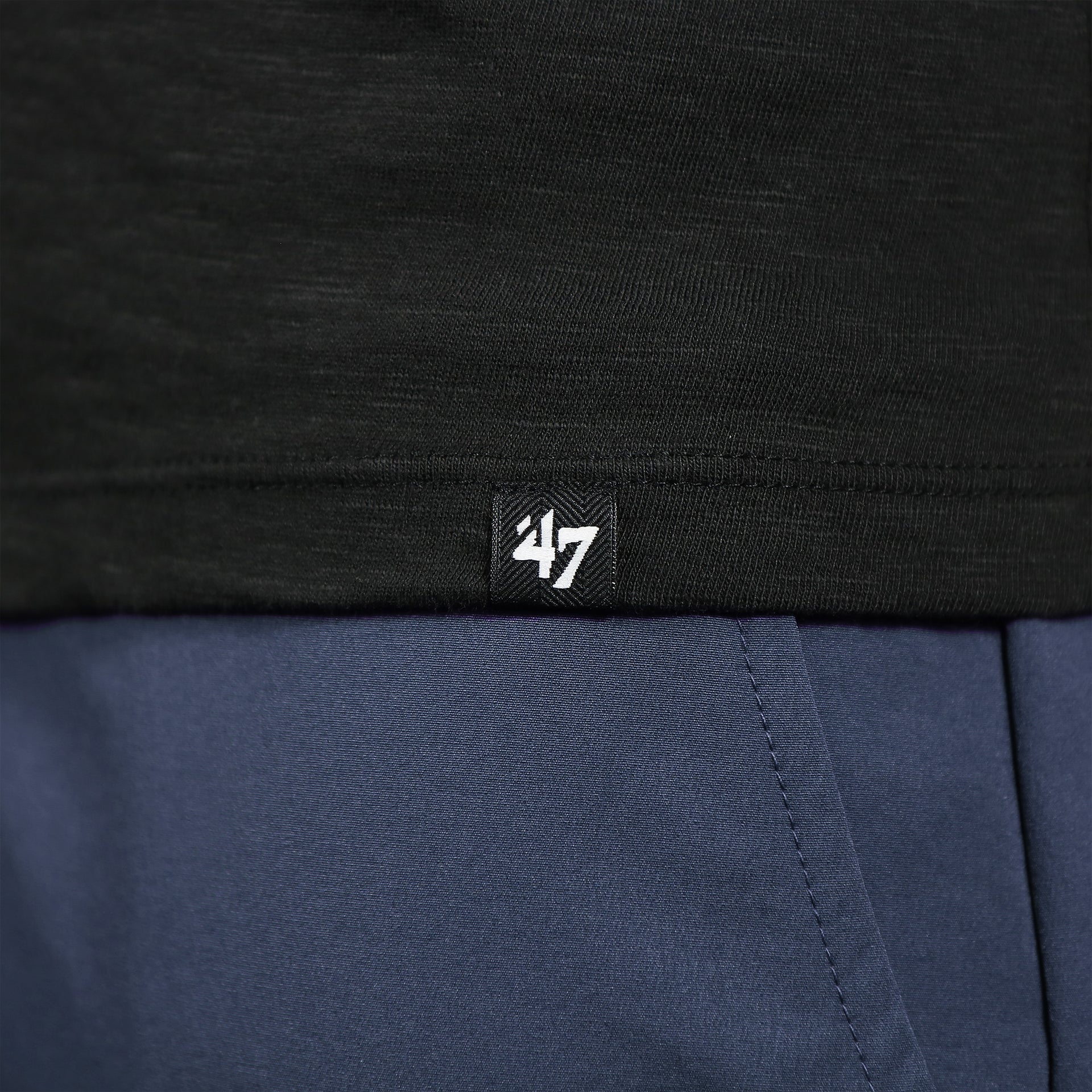 Close up of the 47 label on the front of the Philadelphia Flyers Distressed Logo Premium Grit Scrum Black T-Shirt