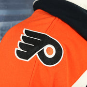 Close up of the shoulder Flyers logo patch on the Philadelphia Flyers Premium Applique Black/Orange/Cream Lacer Hoodie