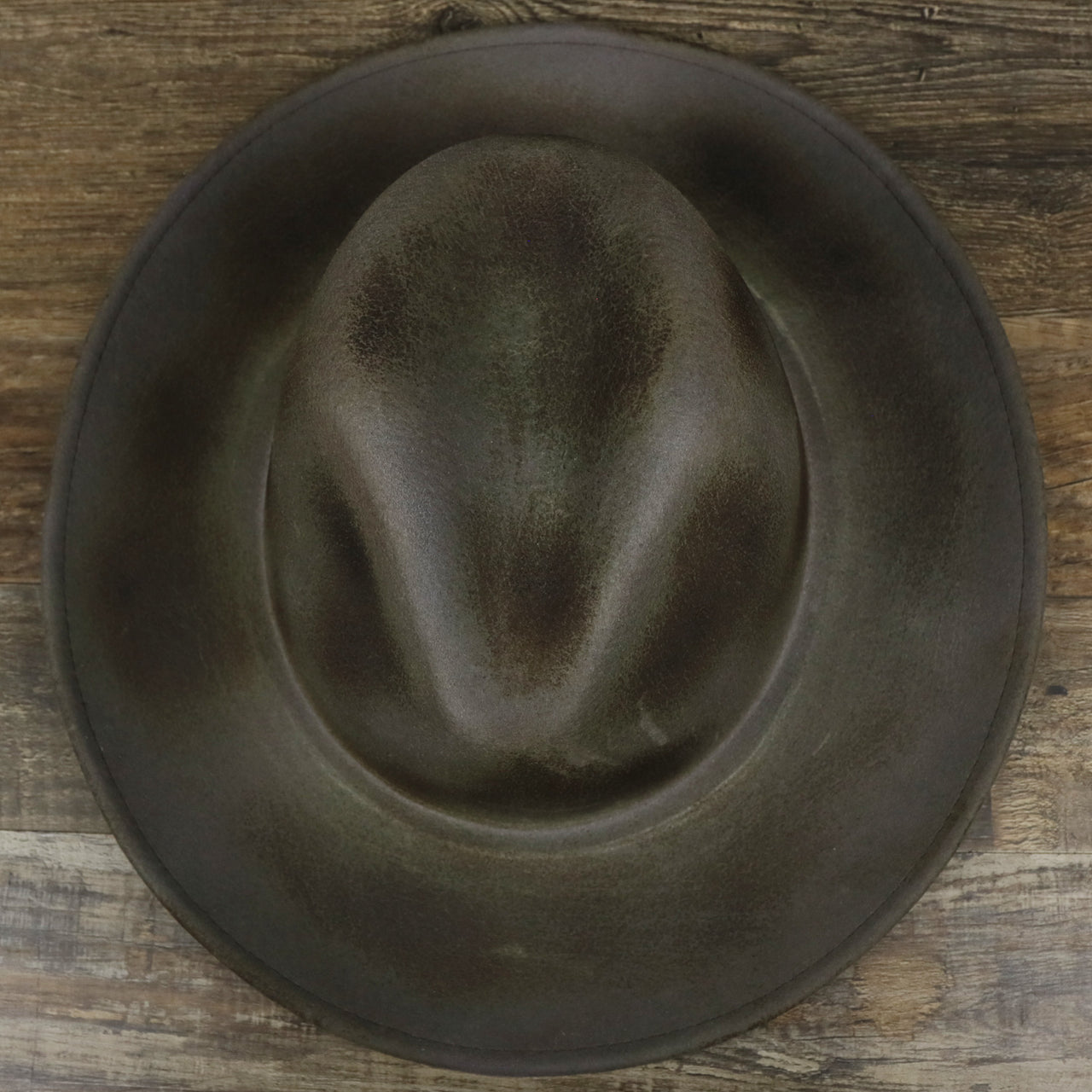 An overhead view of the Wide Brim Ribbon Edge Chared Fedora Hat with Brown Paisley Silk Interior | Zertrue 100% Australian Wool