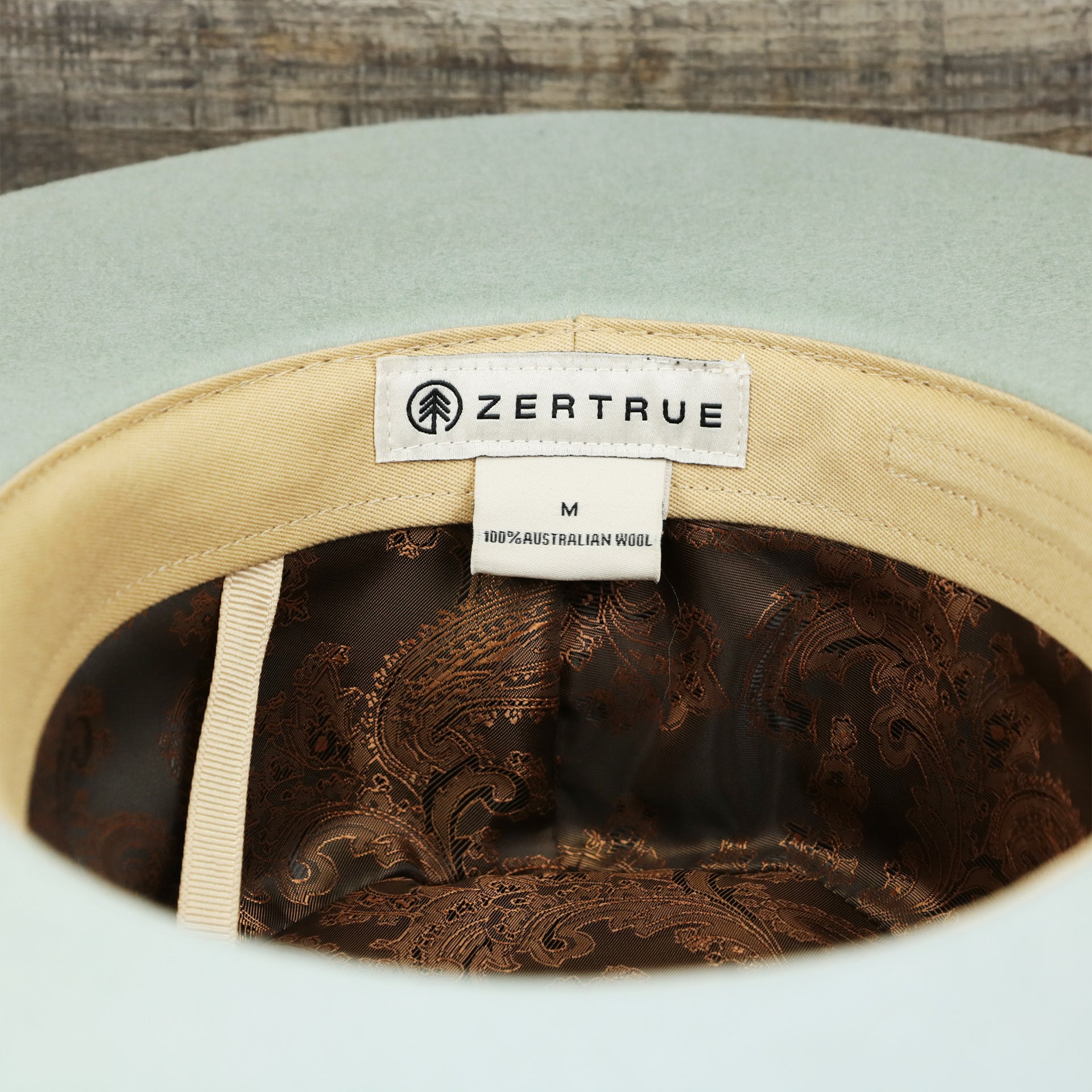 A close up of the underside of the Wide Brim Raw Edge Sage Green Fedora Hat with Brown Paisley Silk Interior | Zertrue 100% Australian Wool