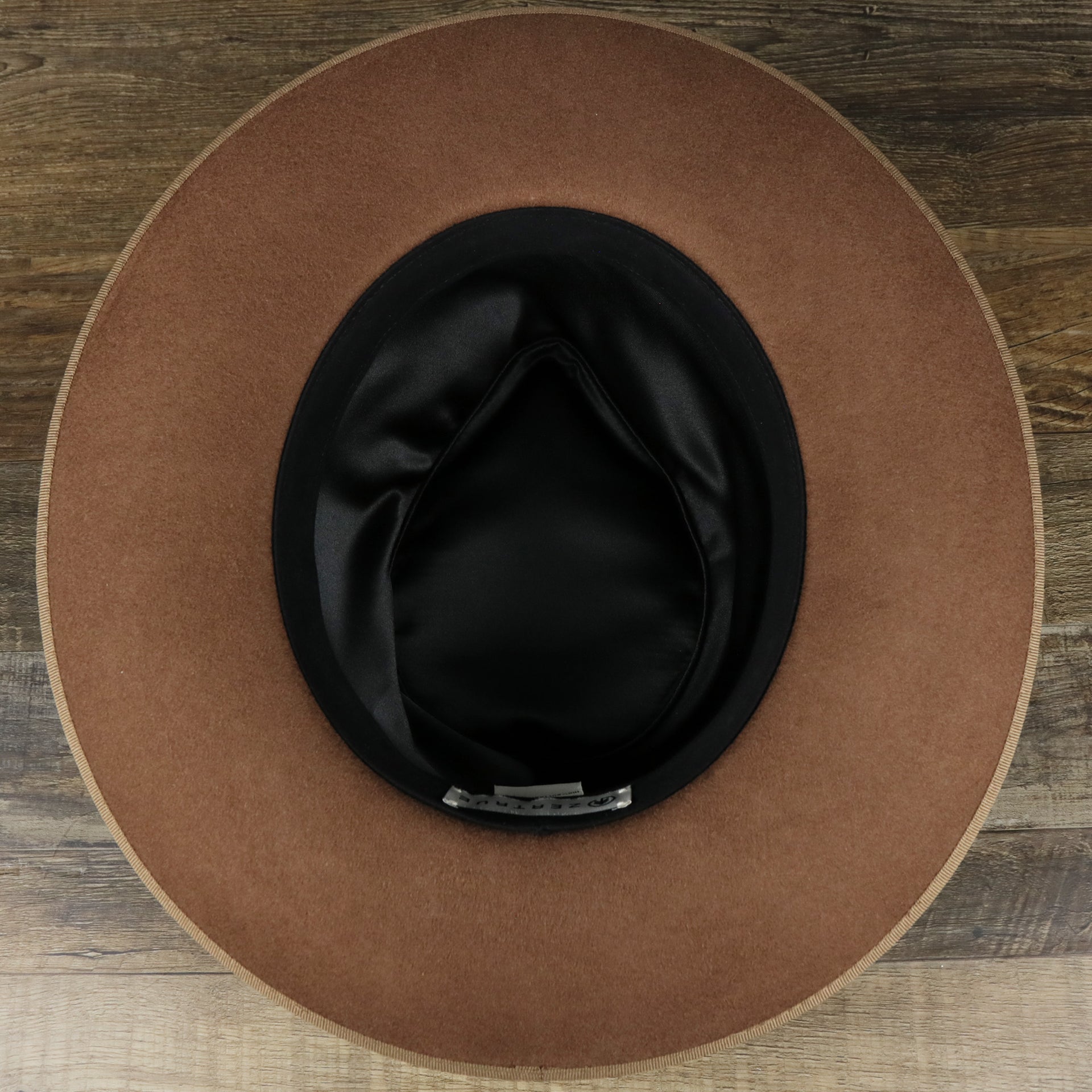 The underside of the Wide Brim Raw Edge Walnut Fedora Hat with Brown Paisley Silk Interior | Zertrue 100% Australian Wool