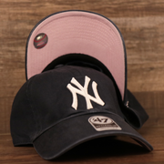 Front and bottom view of the navy blue New York Yankees pink bottom dad hat by 47 Brand.