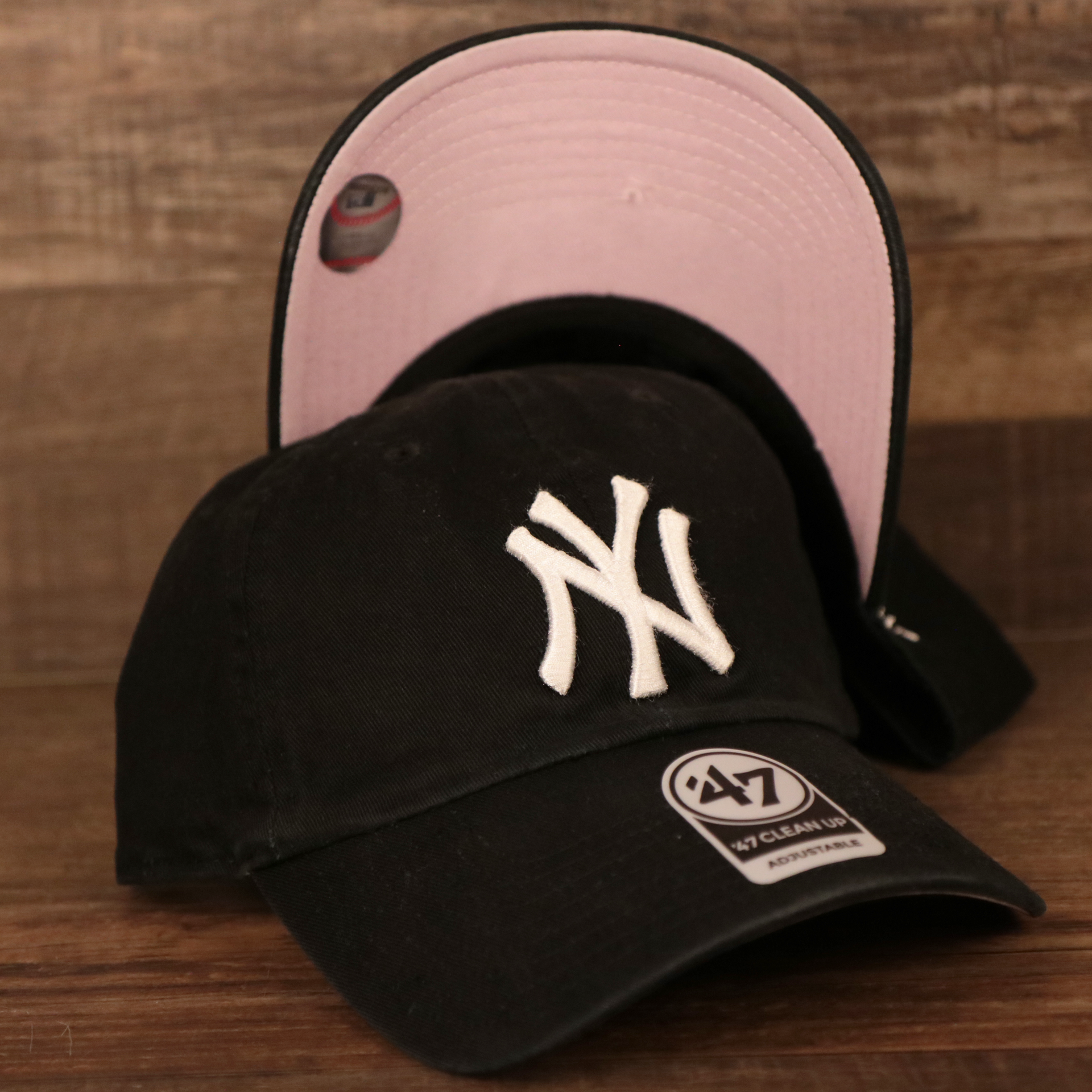 The top and bottom view of this cotton black New York Yankees pink bottom dad hat by 47 Brand.