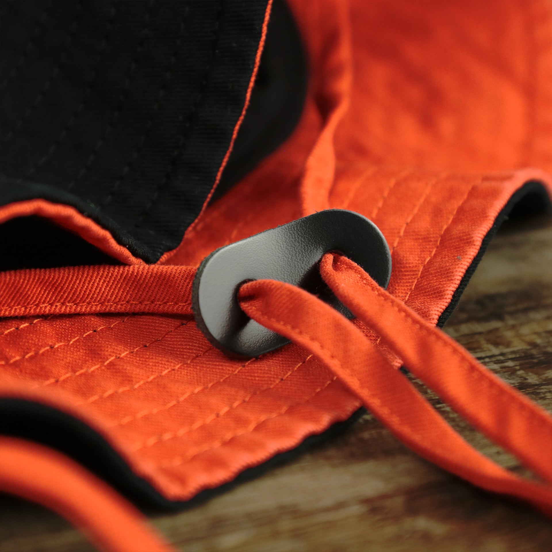 The Chin Strap on the Philadelphia Flyers Logo Orange Undervisor Bucket Hat | Black Bucket Hat