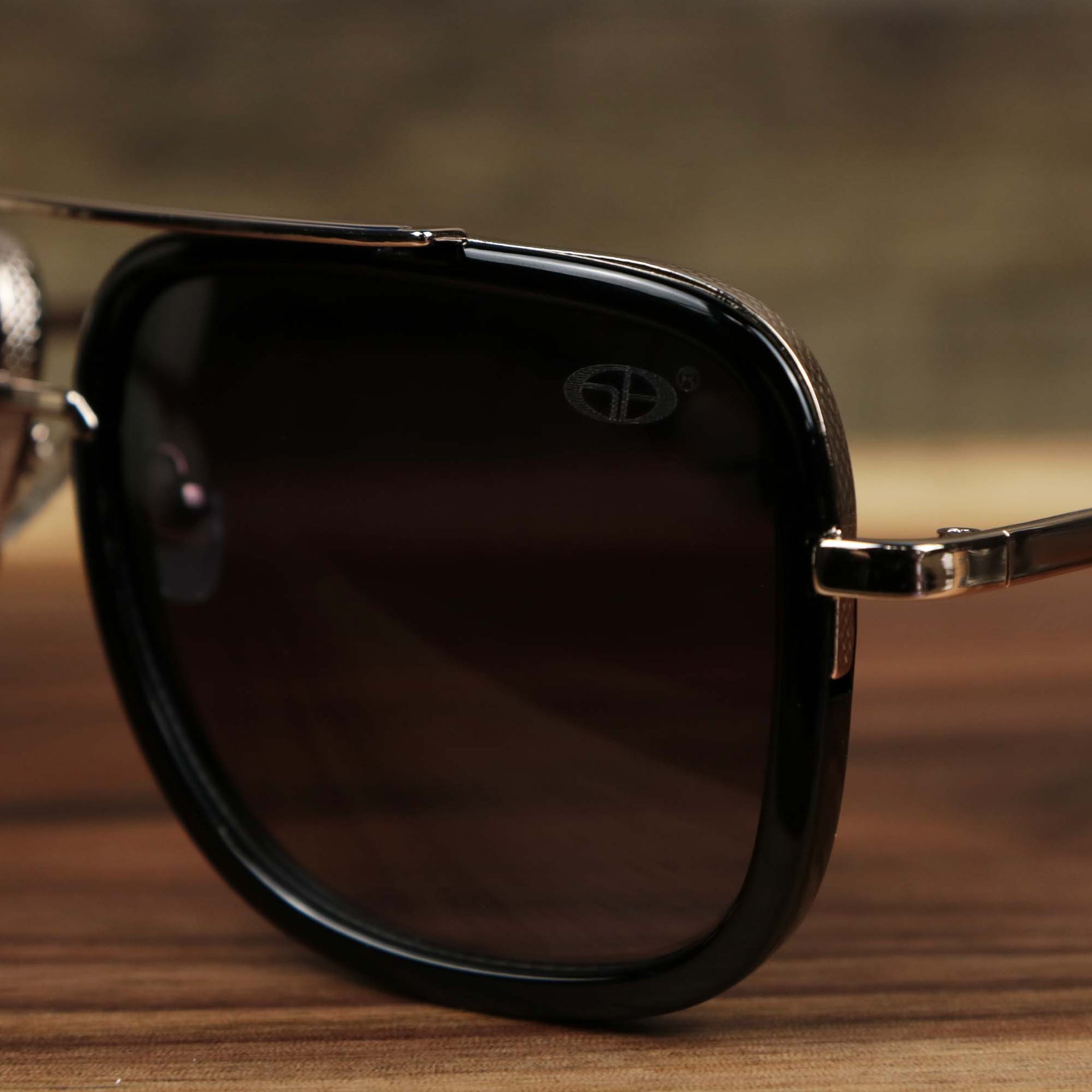 The hinge on the Round Frames Black Lens Sunglasses with Black Gold Frame