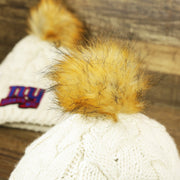 The Meeko Pom Pom on the Women’s New York Giants 2022 NFC Cuffed Winter Knit Meeko Pom Pom Beanie | Women’s White Winter Beanies