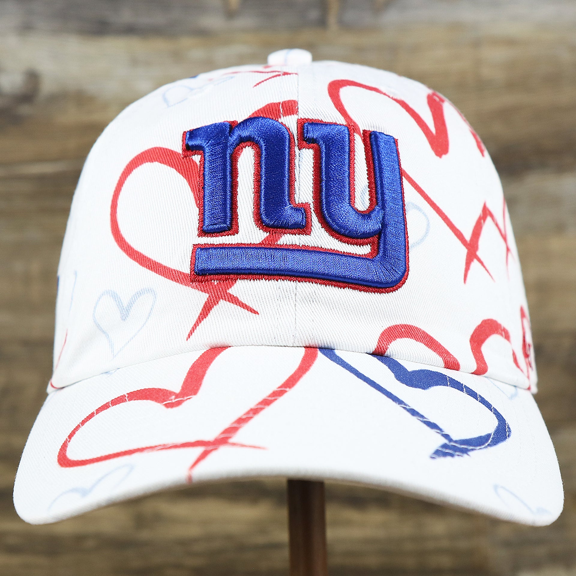 The front of the Kids New York Giants Hearts All Over Print Dad Hat | White Kid’s Dad Hat