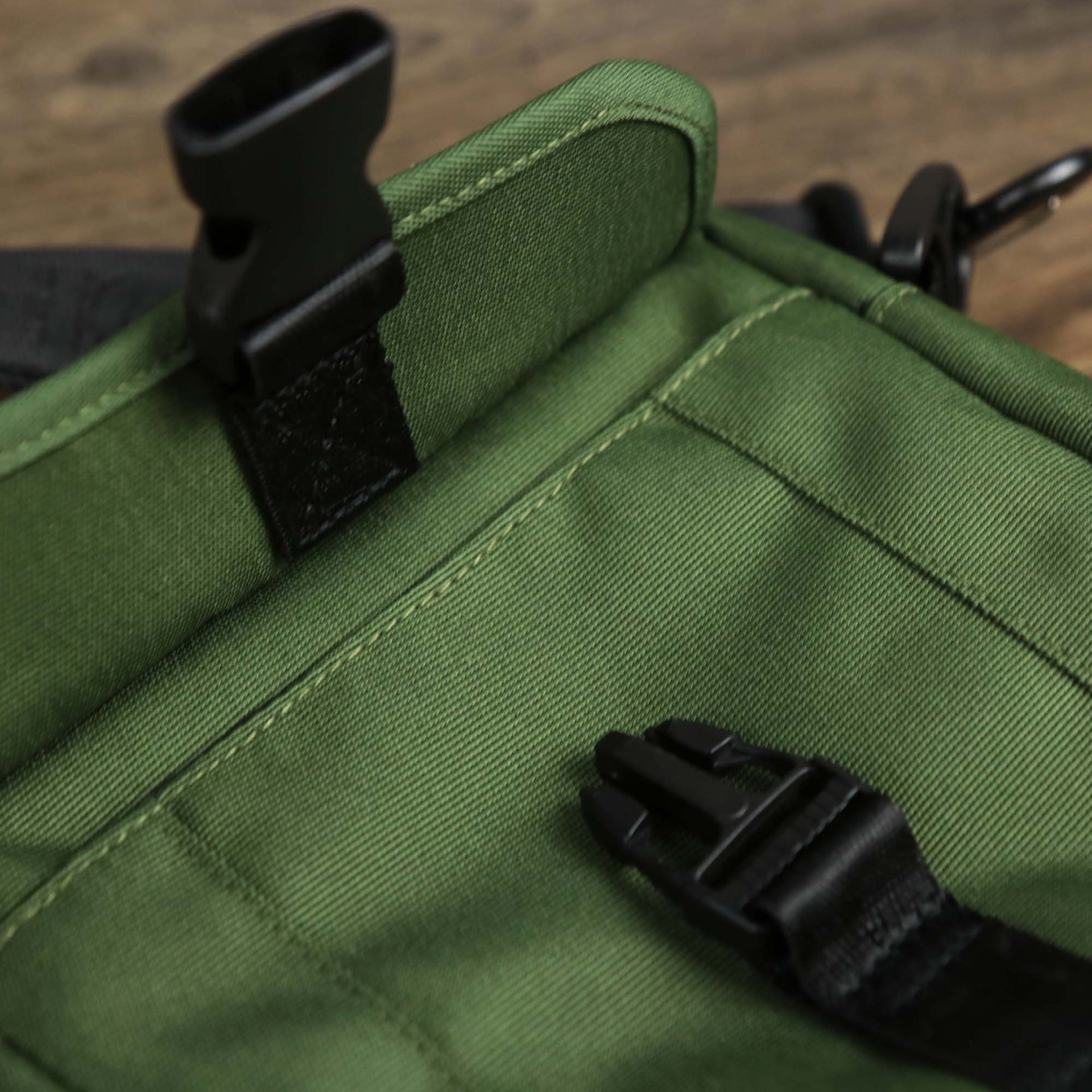 The clasp open on the Essential Nylon Shoulder Bag Streetwear with Mesh Pocket | Official Olive