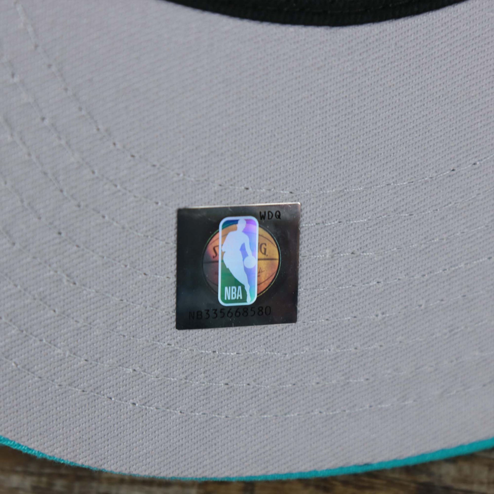 The NBA Jerry West Sticker on the Charlotte Hornets NBA 2022 Draft Gray Bottom 9Fifty Snapback | New Era Cream/Turquoise