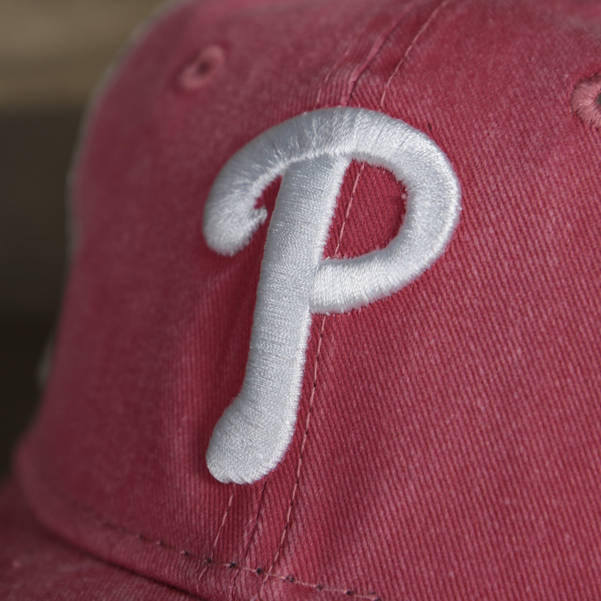A close up of the Phillies logo on the Philadelphia Phillies New Era 9Twenty Washed Trucker Youth hat