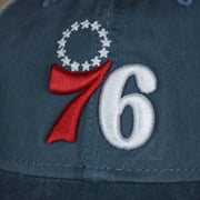 A close up of the 76ers logo on the Philadelphia 76ers New Era 9Twenty Washed Trucker hat