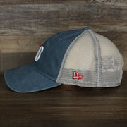 The wearer's left on the Philadelphia 76ers New Era 9Twenty Washed Trucker hat