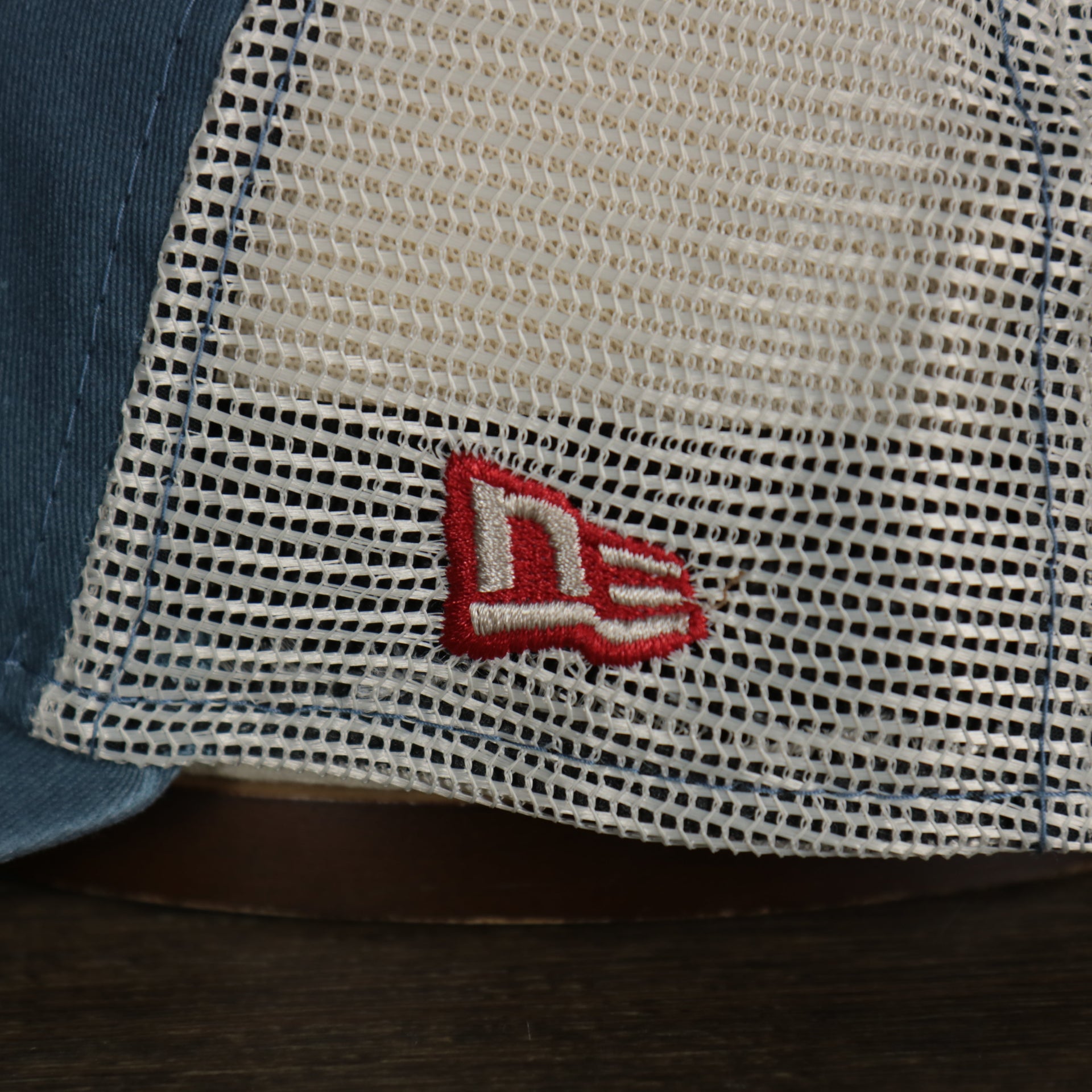 A close up of the New Era logo on the Philadelphia 76ers New Era 9Twenty Washed Trucker hat